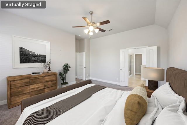 carpeted bedroom featuring ceiling fan and vaulted ceiling