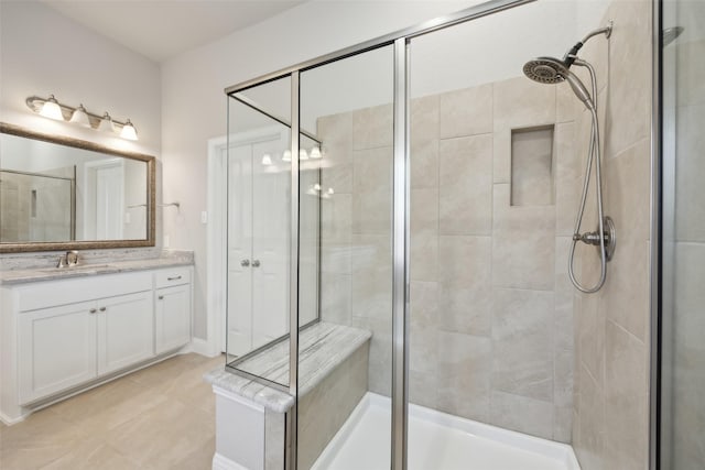 bathroom with vanity and a shower with shower door