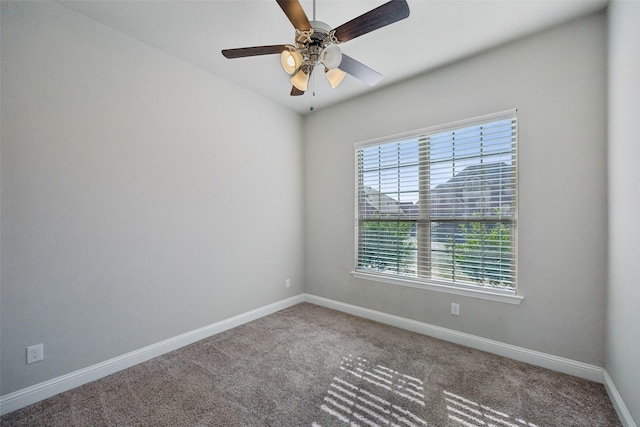 carpeted spare room featuring ceiling fan