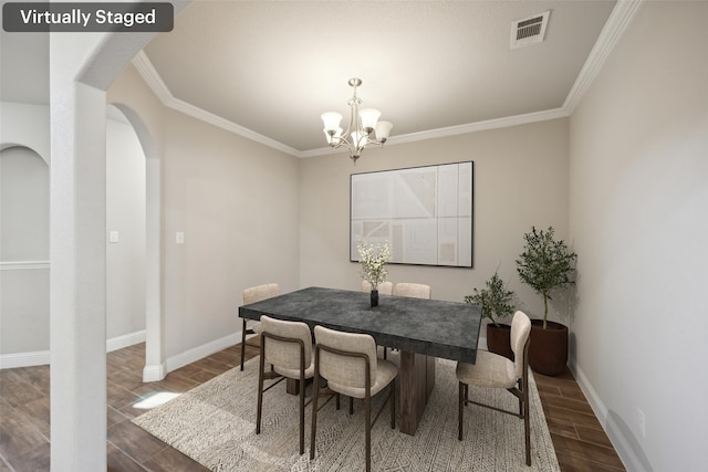 dining room with crown molding and a notable chandelier