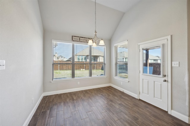 unfurnished dining area with a chandelier and vaulted ceiling