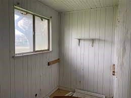 unfurnished room featuring wood walls