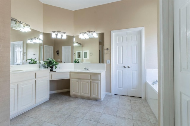 full bathroom featuring tile patterned floors, a bath, and vanity