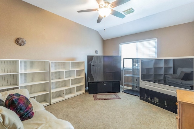 living room with lofted ceiling, visible vents, a ceiling fan, and light colored carpet