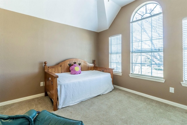 bedroom featuring lofted ceiling, light colored carpet, and baseboards