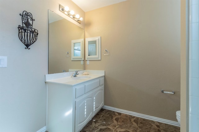 full bathroom with vanity, toilet, and baseboards