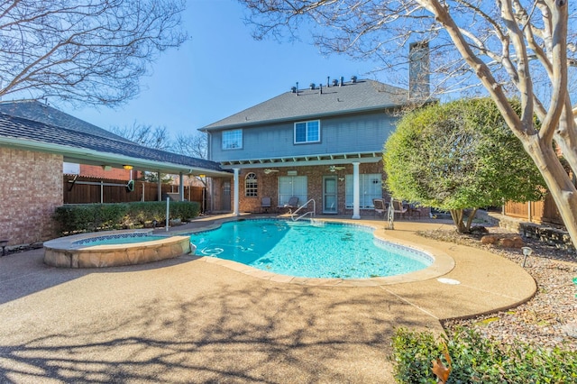 back of house with a patio area, brick siding, a chimney, and fence