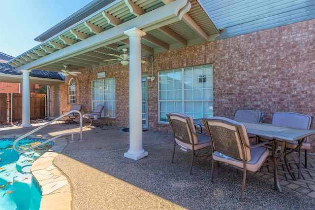 view of patio featuring outdoor dining area, fence, a ceiling fan, and a fenced in pool