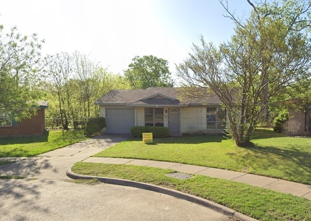 ranch-style home featuring a garage and a front lawn