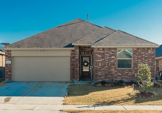 ranch-style house featuring a front yard and a garage