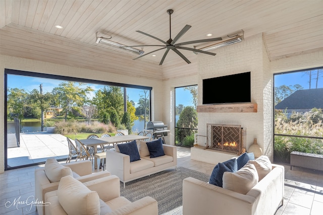 living area featuring a large fireplace, wood ceiling, radiator heating unit, tile patterned floors, and recessed lighting