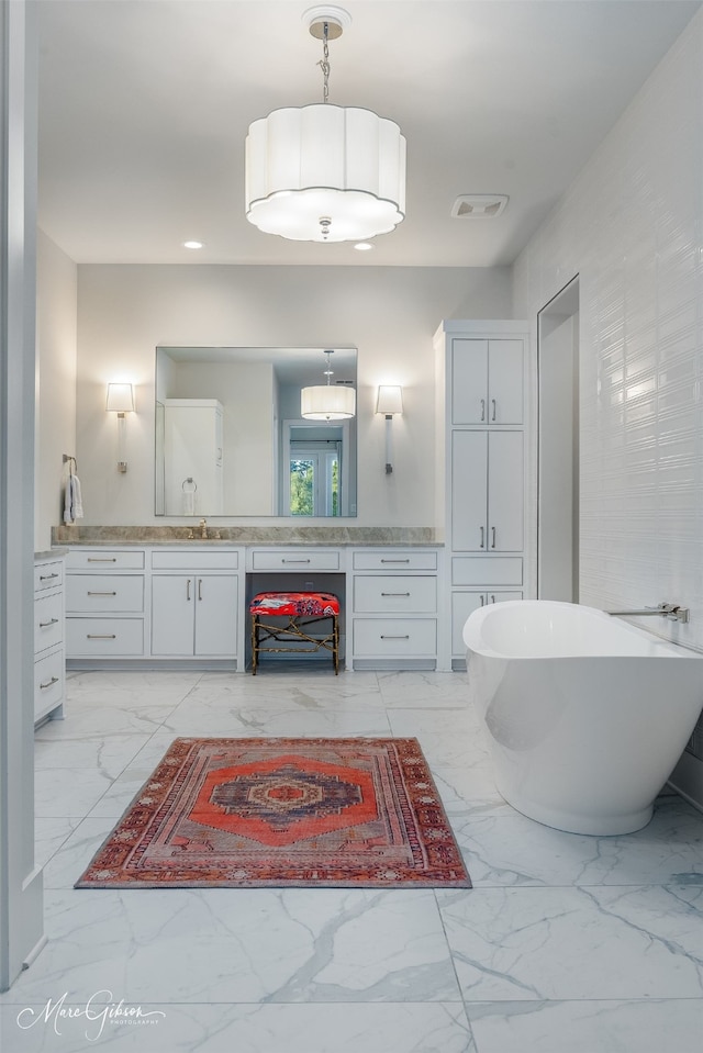 bathroom with vanity and a bathtub