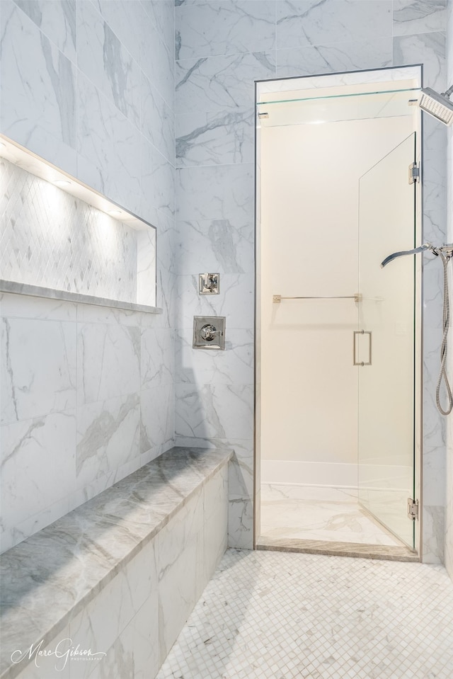 bathroom with a marble finish shower