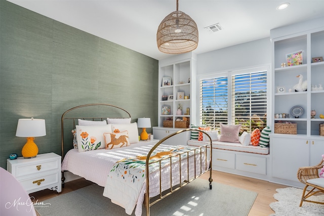 bedroom with wallpapered walls, wood finished floors, visible vents, and recessed lighting