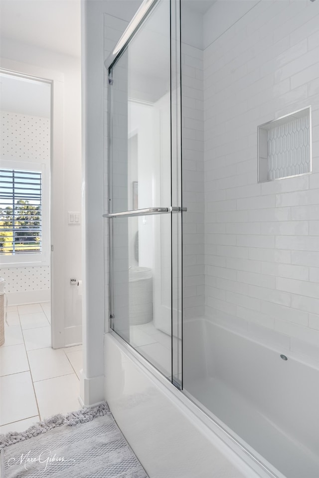 bathroom with enclosed tub / shower combo and tile patterned flooring