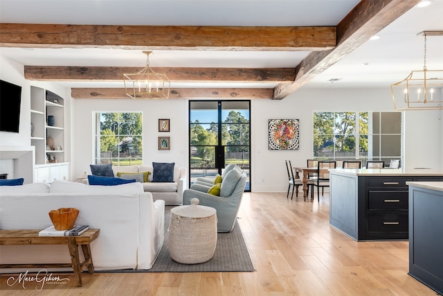 living room featuring beam ceiling, a notable chandelier, and light wood-type flooring