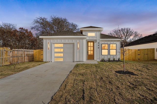 view of front of home with a lawn and a garage