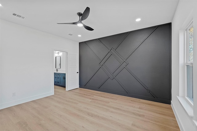 spare room featuring light wood-type flooring and ceiling fan