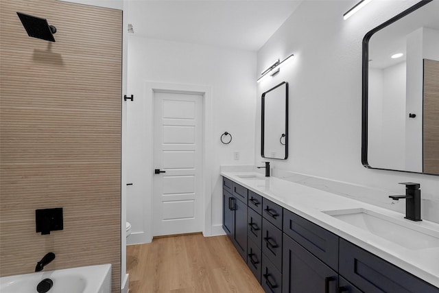 bathroom with hardwood / wood-style floors, vanity, and toilet