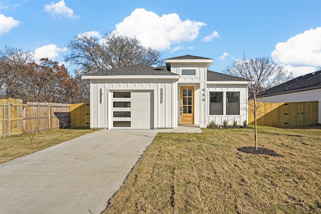 prairie-style home featuring a garage and a front yard