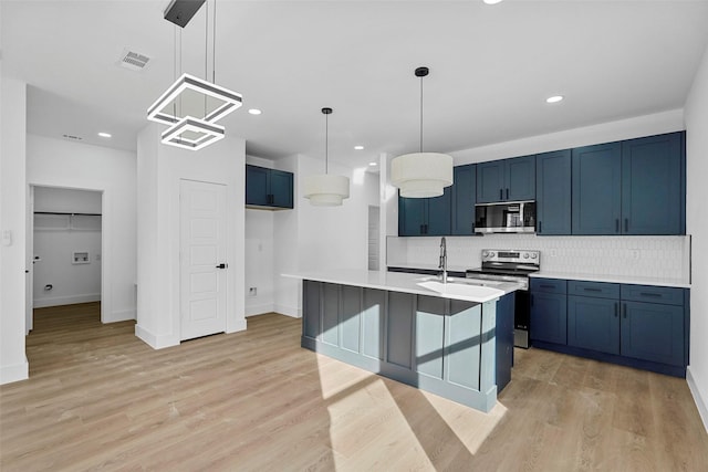 kitchen with blue cabinetry, decorative backsplash, hanging light fixtures, and appliances with stainless steel finishes