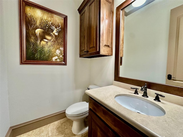 bathroom with toilet, tile patterned floors, and vanity