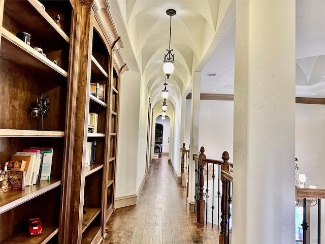 hallway with wood-type flooring and lofted ceiling