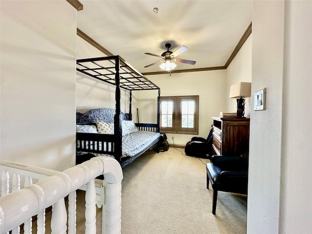 carpeted bedroom with ornamental molding and ceiling fan