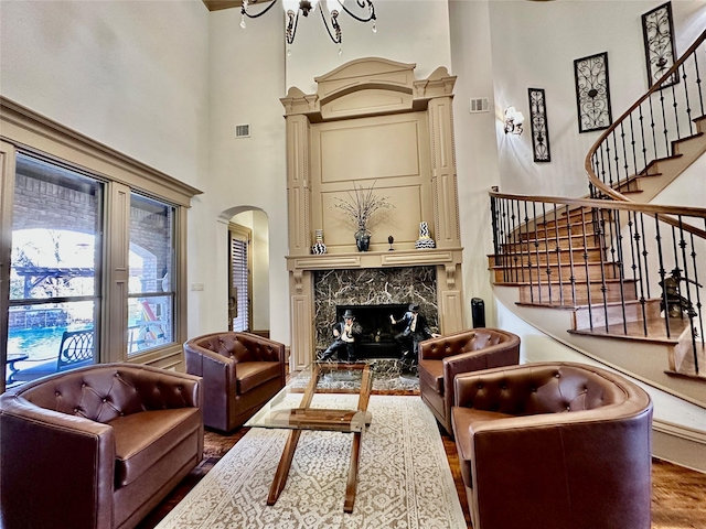 interior space featuring hardwood / wood-style flooring, a high ceiling, and a fireplace