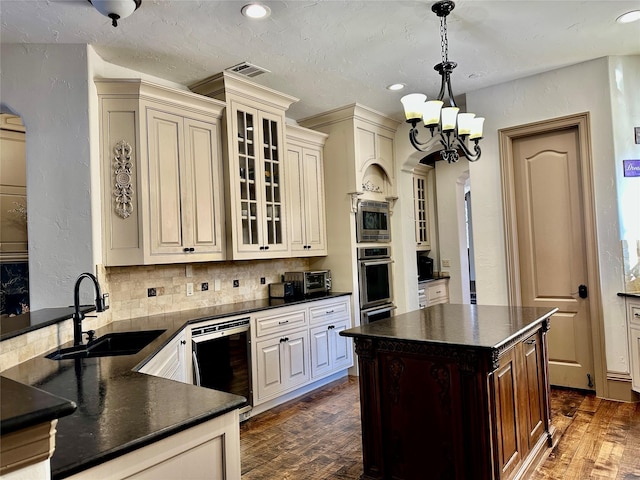 kitchen featuring an inviting chandelier, wine cooler, sink, hanging light fixtures, and cream cabinetry