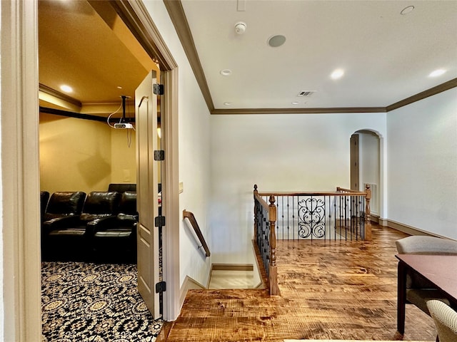 corridor with hardwood / wood-style floors and crown molding