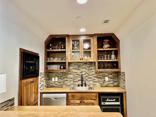 bar with tasteful backsplash, dishwasher, and sink