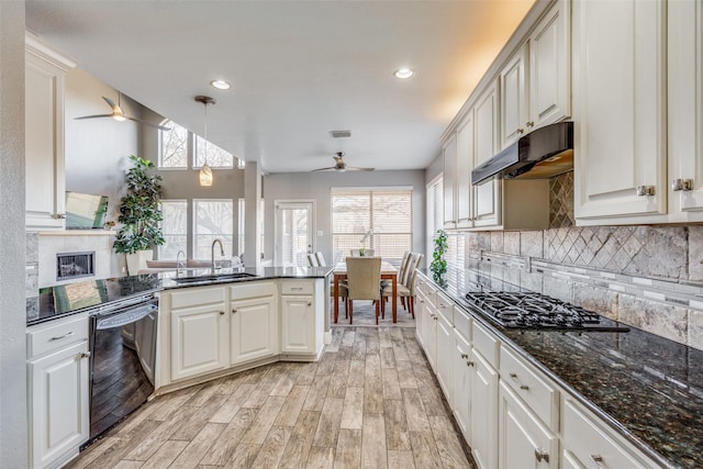 kitchen with gas cooktop, sink, light hardwood / wood-style flooring, black dishwasher, and hanging light fixtures