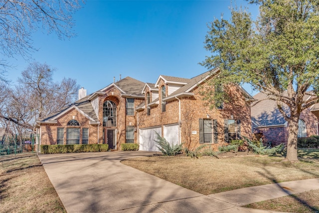 view of front of property with a garage and a front lawn