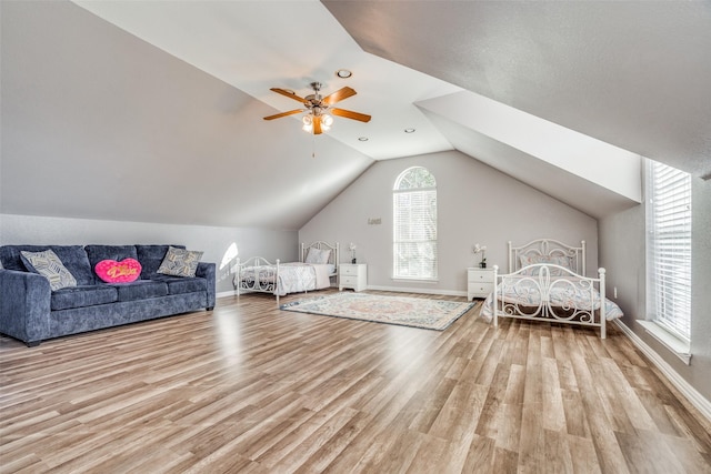 bedroom featuring light hardwood / wood-style floors, ceiling fan, and lofted ceiling