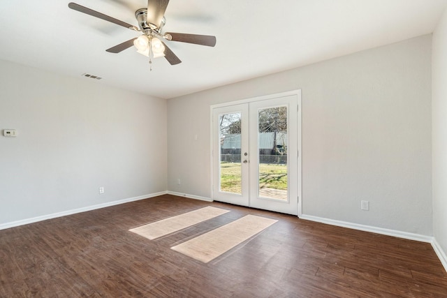 spare room featuring ceiling fan, french doors, and dark wood-type flooring