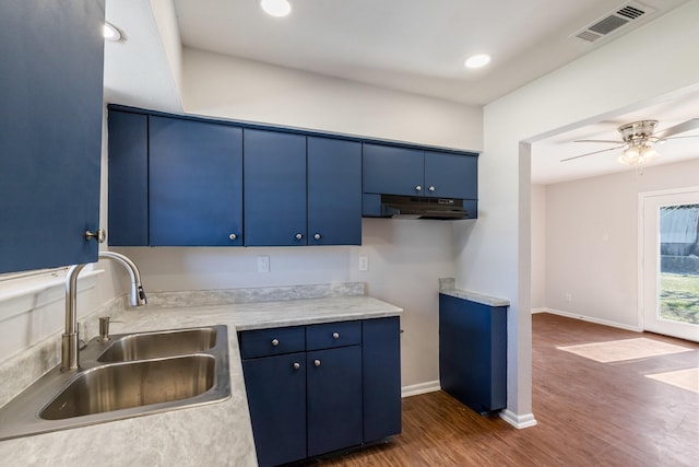 kitchen with blue cabinets, ceiling fan, dark hardwood / wood-style flooring, and sink