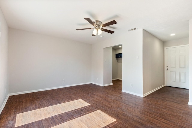 spare room featuring ceiling fan and dark wood-type flooring