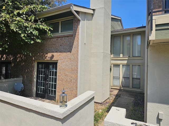 view of side of home featuring french doors