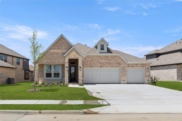 13732 Riola Dr, Little Elm, TX 75068 - view of front of property featuring a garage, concrete driveway, cooling unit, brick siding, and a front yard