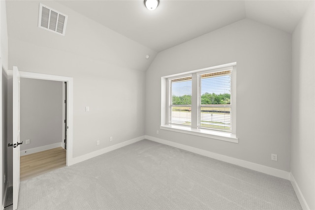 13732 Riola Dr, Little Elm, TX 75068 - spare room with vaulted ceiling, light colored carpet, and baseboards