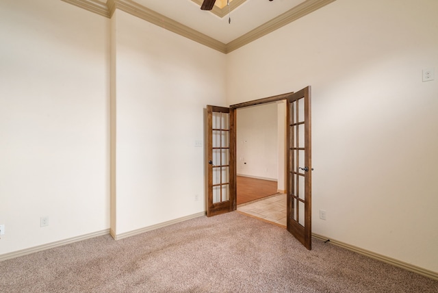 spare room with french doors, light carpet, ceiling fan, and ornamental molding