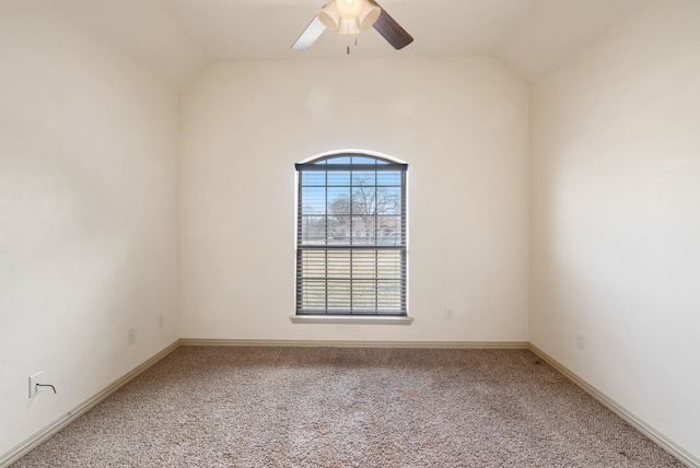 carpeted empty room with ceiling fan and vaulted ceiling