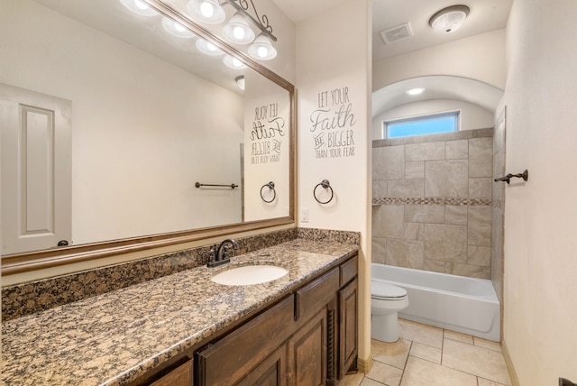 full bathroom with toilet, vanity, tile patterned flooring, and tiled shower / bath combo