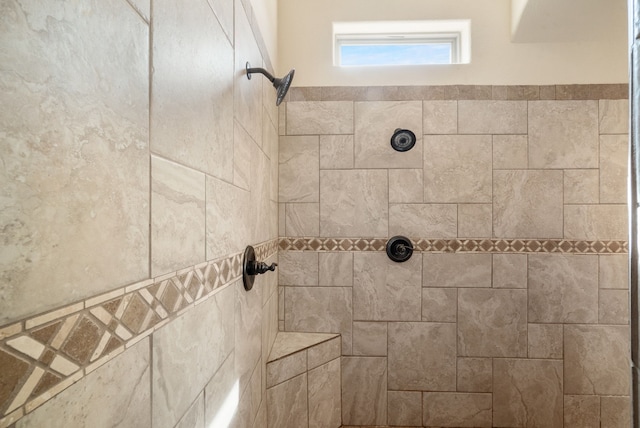 bathroom with tiled shower