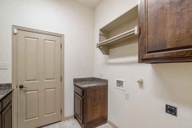 laundry area with electric dryer hookup, cabinets, light tile patterned flooring, and washer hookup