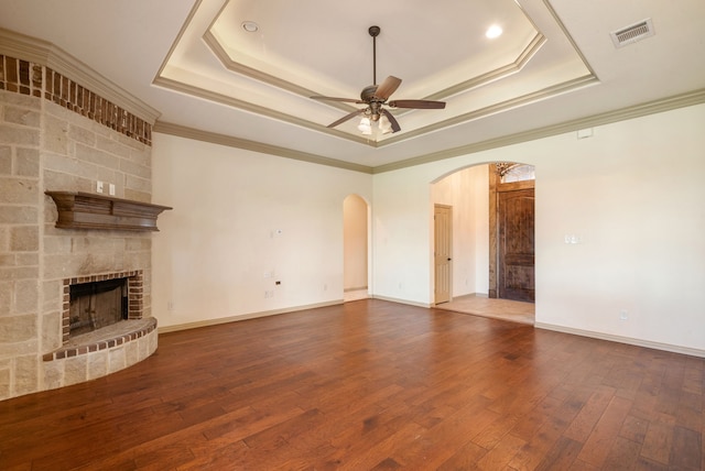 unfurnished living room featuring a tray ceiling and crown molding