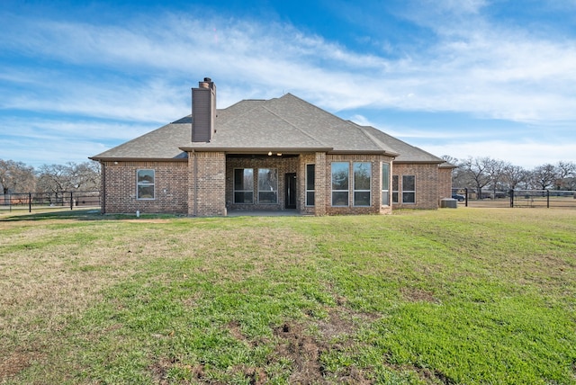 rear view of property with a yard