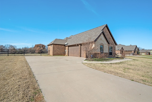 view of side of property with a yard and a garage