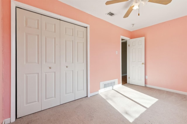 unfurnished bedroom with ceiling fan, carpet floors, and a closet